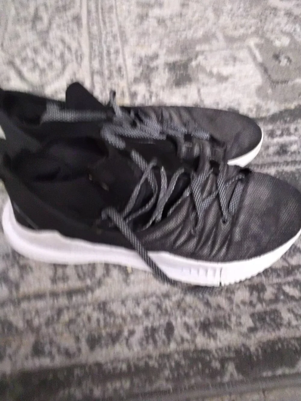 The Size 10 Under Armour Curry 5 Black sneakers are a stylish and comfortable op